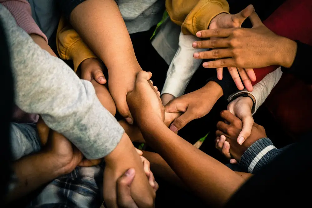 Hands of many community members joined together